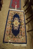 SMALL CHINESE WOOL FLOOR RUG DECORATED WITH FLOWERS ON A BLUE BACKGROUND, 150CM LONG