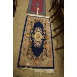 SMALL CHINESE WOOL FLOOR RUG DECORATED WITH FLOWERS ON A BLUE BACKGROUND, 150CM LONG