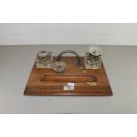 LATE 19TH/EARLY 20TH CENTURY OAK DESK STAND FITTED WITH TWO CLEAR GLASS INK BOTTLES