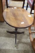 SMALL OVAL TOPPED MAHOGANY WINE TABLE ON TURNED COLUMN AND TRIPOD BASE WITH BRASS END CAPS AND