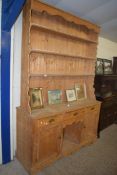 LARGE PINE DOG KENNEL STYLE DRESSER, THE BACK WITH THREE SHELVES OVER A BASE WITH THREE DRAWERS, TWO