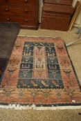 20TH CENTURY MIDDLE EASTERN WOOL FLOOR RUG DECORATED WITH STYLISED BIRDS AND ANIMALS, 180CM LONG