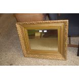 19TH CENTURY FOLIATE MOULDED GILT PICTURE FRAME, NOW CONTAINING A BEVELLED MIRROR, 76CM WIDE