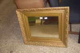 19TH CENTURY FOLIATE MOULDED GILT PICTURE FRAME, NOW CONTAINING A BEVELLED MIRROR, 76CM WIDE