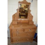 PINE DRESSING CHEST WITH MIRRORED BACK OVER A BODY WITH FOUR SMALL DRAWERS AND TWO LONG DRAWERS,