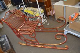 RED PAINTED METAL SLEIGH FORM SEAT, APPROX 140CM WIDE
