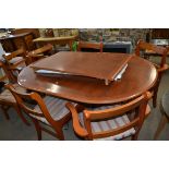 YEW WOOD TWIN PEDESTAL EXTENDING DINING TABLE AND SIX ACCOMPANYING CHAIRS