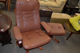 LEATHER UPHOLSTERED REVOLVING CHAIR AND ACCOMPANYING FOOT STOOL