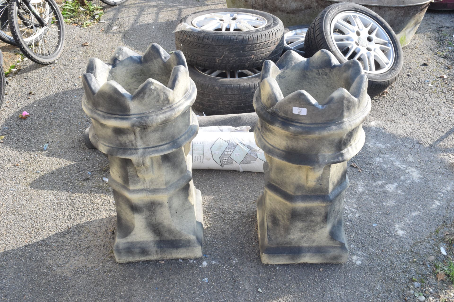 TWO COMPOSITE GARDEN PLANTERS IN THE SHAPE OF CHIMNEYS