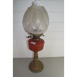 LATE VICTORIAN OIL LAMP WITH FROSTED GLASS SHADE, RED GLASS FONT AND BRASS BASE