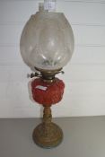 LATE VICTORIAN OIL LAMP WITH FROSTED GLASS SHADE, RED GLASS FONT AND BRASS BASE