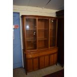 NATHAN TEAK LOUNGE DISPLAY CABINET, THE TOP SECTION WITH GLAZED DOORS OVER A BASE WITH THREE DRAWERS