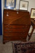 REPRODUCTION MAHOGANY BUREAU WITH FALL FRONT OPENING TO A FITTED INTERIOR OVER A FOUR DRAWER BASE