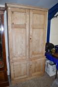 PINE TWO SECTION CUPBOARD WITH FOUR PANELLED DOORS AND SHELVED INTERIOR, 124CM HIGH