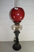 VICTORIAN OIL LAMP WITH RED GLASS SHADE, CLEAR GLASS FONT AND METAL STEM