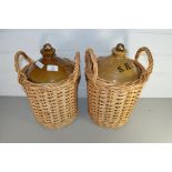 TWO SUPPLY RESERVE DEPOT (SRD) STONEWARE FLAGONS IN WICKER CARRIERS