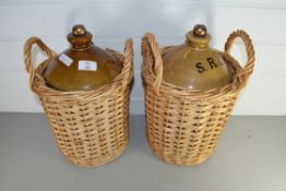 TWO SUPPLY RESERVE DEPOT (SRD) STONEWARE FLAGONS IN WICKER CARRIERS