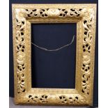 An elaborately carved floral gilt frame. Approx 44x34 inches.