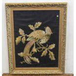 A decorative embroidery of a bird with foliage on black background . NA. Approx 17x13 inches.