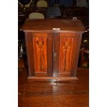 Late 19th century wall mounted mahogany smoker's cabinet with panelled doors decorated with Art