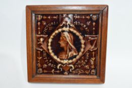Treacle glaze tile, the centre with image of Queen Victoria, the tile in wooden frame, 18cm width