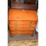 George III faded mahogany bureau with fall front opening to a shelved interior over four long