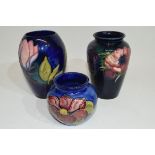 Group of three Moorcroft vases with tube lined floral designs