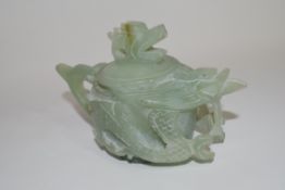 Green soapstone Chinese tea pot, modelled in relief with dragons and dragon finial, 9cm high