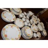 An extensive Wedgwood dinner service in the trellis flower pattern including 8 dinner plates, side