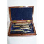 Mahogany cased drawing instruments, the hinged lid with lift up velvet padded compartment, beneath