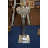 Late 19th century oil lamp, clear glass font, raised on a silver plated Corinthian column and a