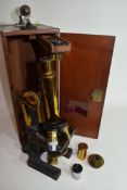 W Watson & Sons, High Holborn, London, Praxis microscope finished in black and brass lacquer, approx