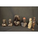 Group of six various hardwood African tribal carved figures together with a further carved stone