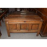 18th century oak coffer of typical form, three panelled front with hinged lid opening to a void