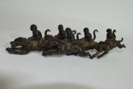 Group of monkey jockeys, metal models with monkeys astride racing dogs, 18cm long