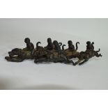 Group of monkey jockeys, metal models with monkeys astride racing dogs, 18cm long