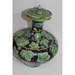 Della Robbia pottery vase, the brown ground with a green leaf decoration, factory mark to base