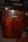 19th century mahogany corner cabinet of large proportions, the bow front body with two panelled