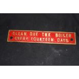Small cast brass plaque marked "Clean out the boiler every 14 days", 25cm wide