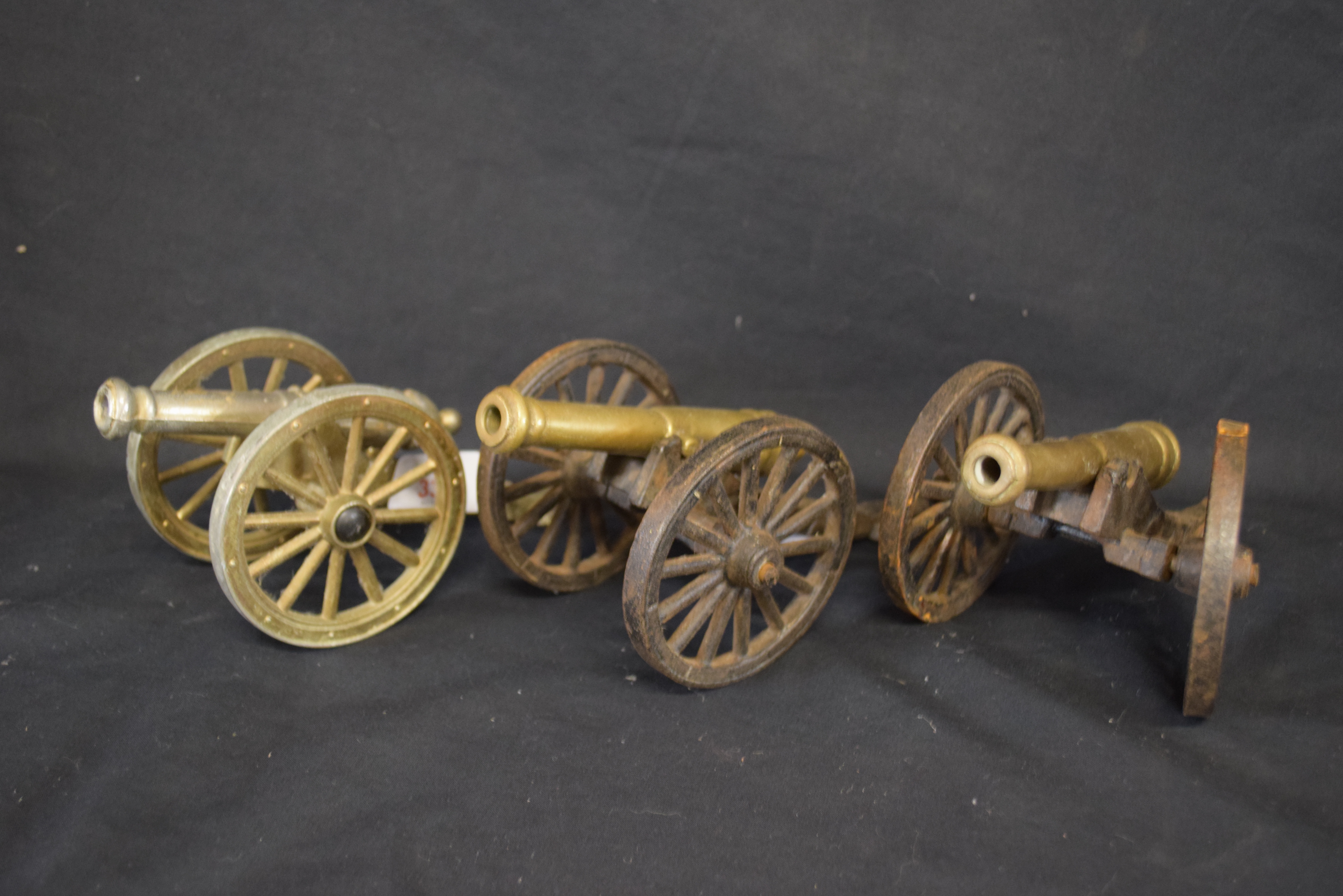 Group of three 20th century cast metal models of cannons, approx 10cm high (3)