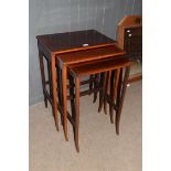 Nest of three Edwardian mahogany and inlaid occasional tables on slender legs, largest 49.5cm wide