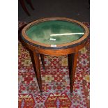 Late 19th century satinwood veneered bijouterie table, the oval glazed top opening to a fabric lined