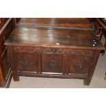 18th century oak coffer with three panelled front, decorated with carved detail and fitted with