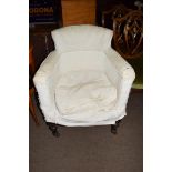 19th century tub chair with hardwood frame and turned front legs with casters, requiring