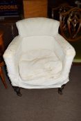 19th century tub chair with hardwood frame and turned front legs with casters, requiring