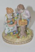 Small porcelain group of a girl and boy picking flowers on an oval base, Dresden mark to underside