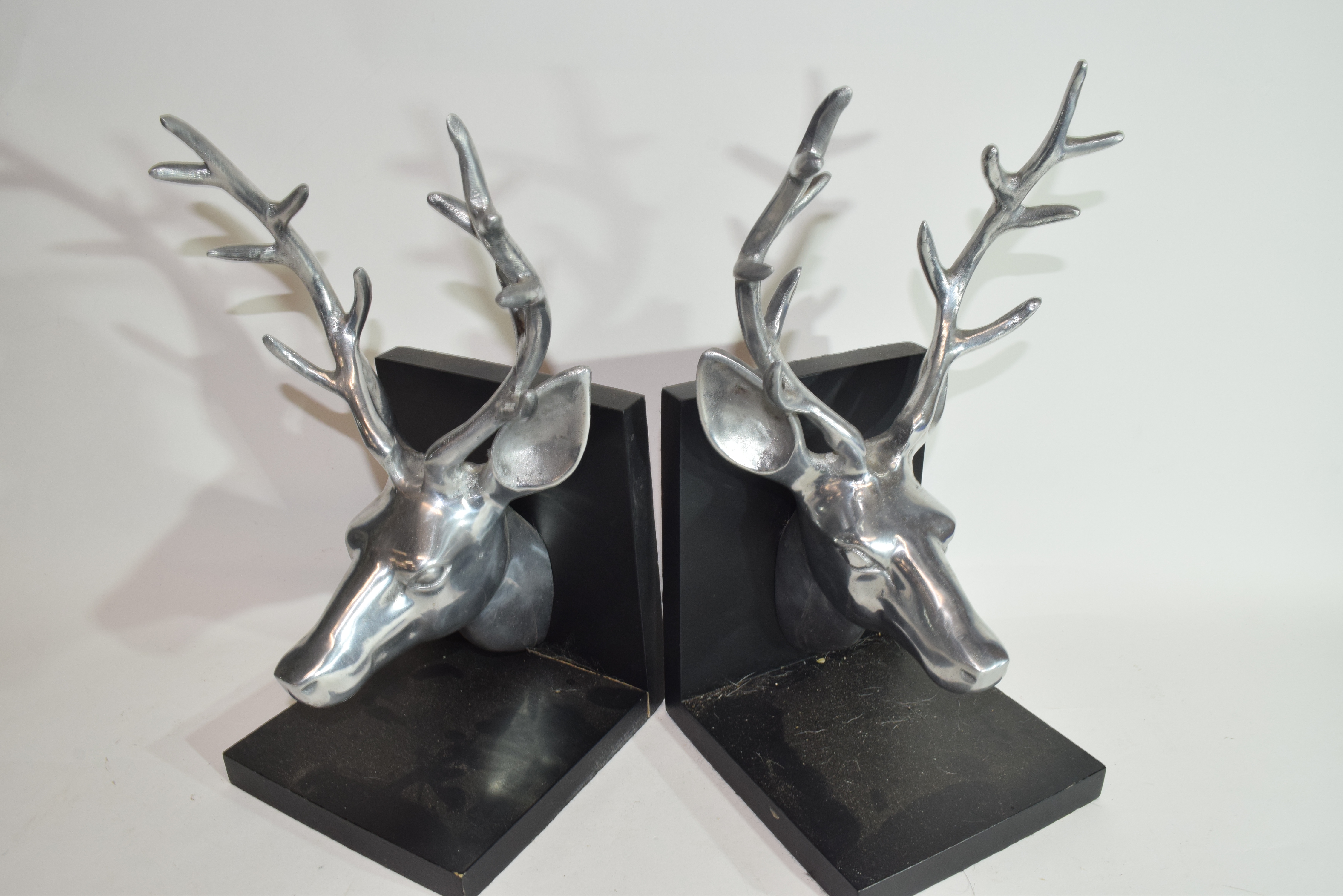 Pair of book ends both modelled with heads of stags in white metal