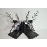 Pair of book ends both modelled with heads of stags in white metal