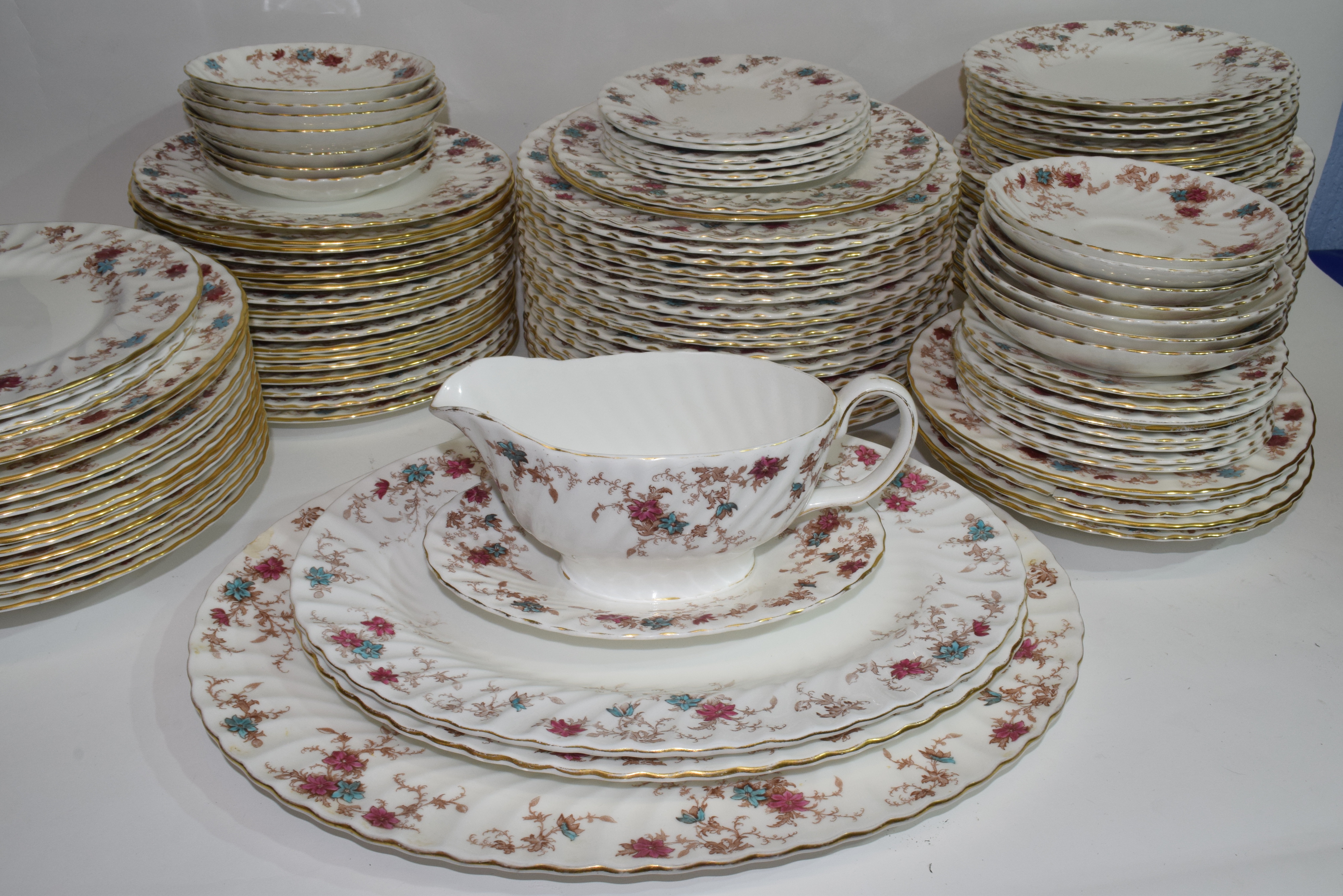 An extensive dinner service by Minton in the Ancestral pattern comprising several hundred pieces