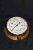 Vintage brass cased pressure gauge with scale in pounds per inch and feet of water, no maker's